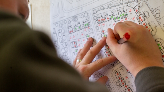 man drawing on a map