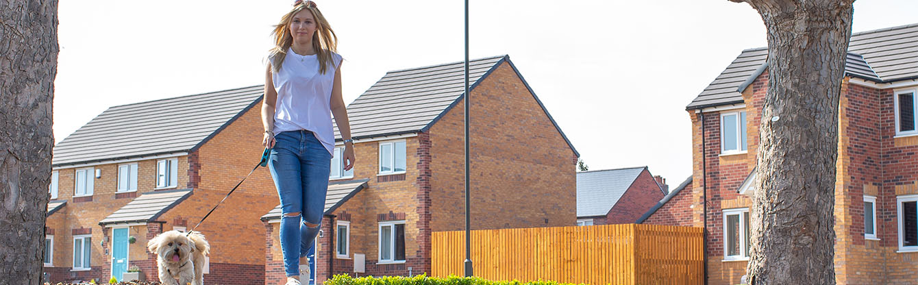 woman walking a dog along modal walk in Derbyshire